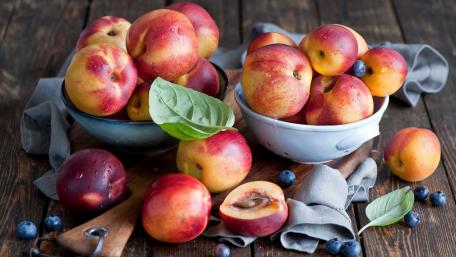 Fresh and Juicy Nectarines on Wooden Table wallpaper