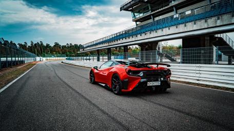 Sleek Red Sports Car on Race Track wallpaper