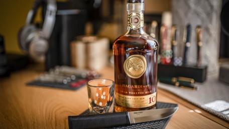 Bacardi Bottle and Knife on a Stylish Desk wallpaper