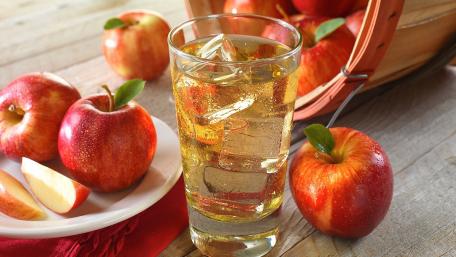 Refreshing Apple Drink with Fresh Apples and Basket Displayed wallpaper