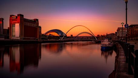 Serene Sunset Over Urban Waters wallpaper