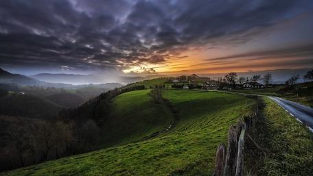 Serene Sunset Over Rolling Hills wallpaper