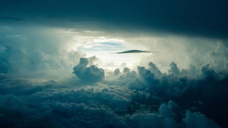 Mystical Blue Heavens: A Cloudy Embrace wallpaper