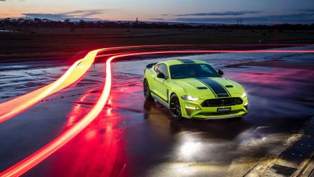 Vibrant Neon Mustang on Wet Pavement wallpaper