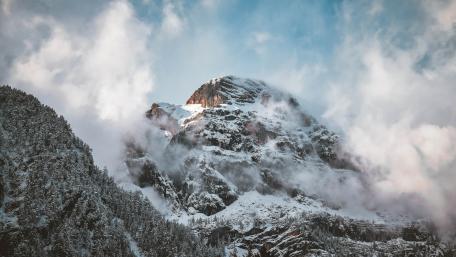 Majestic Mountain Summit Under Dramatic Skies wallpaper