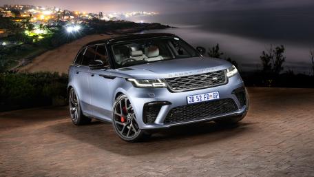 Sleek Range Rover SUV in Urban Nightscape wallpaper