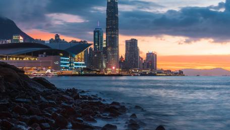 Vibrant Cityscape at Sunset Over Water wallpaper