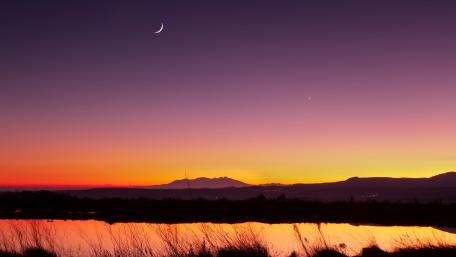 Tranquil Evening by the Lake Under a Crescent Moon wallpaper