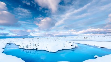 Icelandic Winter Wonderland Scene of Snow and Blue Water wallpaper