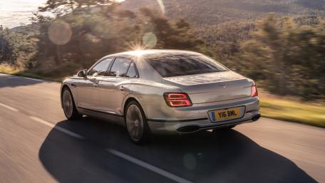 Sleek Silver Luxury Sedan on Scenic Road wallpaper