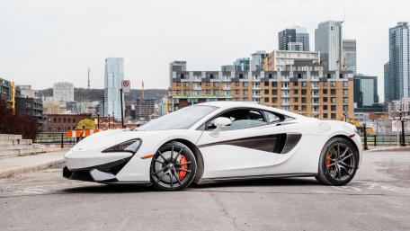 Sleek White McLaren 570S in Urban Setting wallpaper