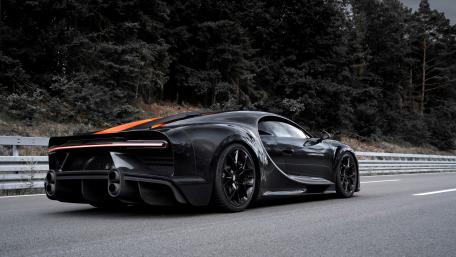 Sleek Black Hypercar on Open Road wallpaper