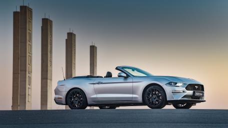 Sleek Silver Convertible Against Urban Landscape wallpaper