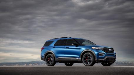 Sleek Blue SUV Against Dramatic Skies wallpaper