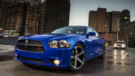 Sleek Blue Charger in Urban Night Scene wallpaper