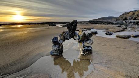 Serene Beach Rock Balancing Artistry wallpaper
