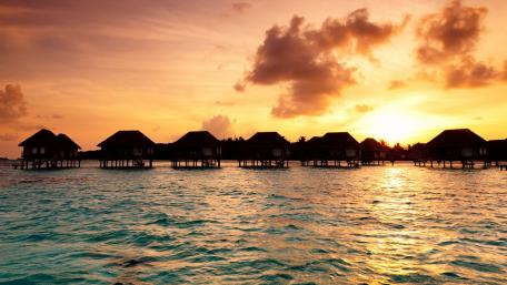 Serenity at Sunset Over Water Bungalows wallpaper