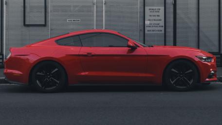 Sleek Red Sports Car in Urban Setting wallpaper