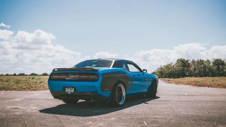 Bold Blue Muscle Car on Open Road wallpaper