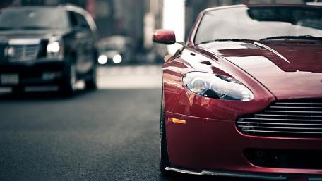Sleek Red Sports Car in Urban Setting wallpaper
