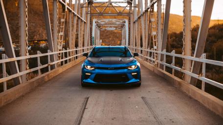 Blue Sports Car on Scenic Bridge wallpaper