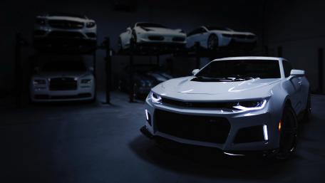 Sleek White Sports Car in a Modern Garage wallpaper