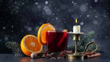 Warm Winter Drink with Citrus Fragrance and Candlelight Glow wallpaper