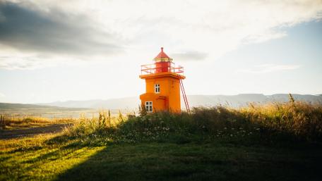 Vibrant Lighthouse Against a Serene Landscape wallpaper