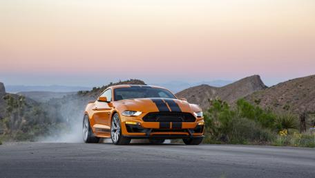 Dynamic Orange Sports Car in Action wallpaper