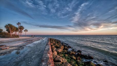 Serene Coastal Sunset Over Calm Waters wallpaper