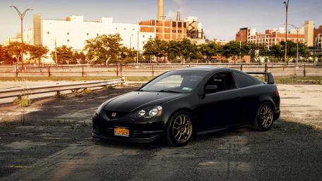 Sleek Black Sports Car in Urban Setting wallpaper