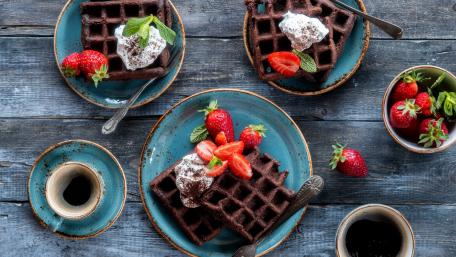 Indulgent Chocolate Waffles with Fresh Strawberries and Creamy Topping wallpaper