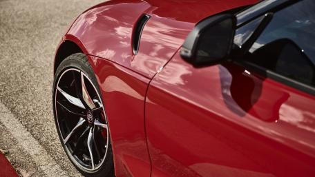 Sleek Red Sports Car Close-Up Design wallpaper