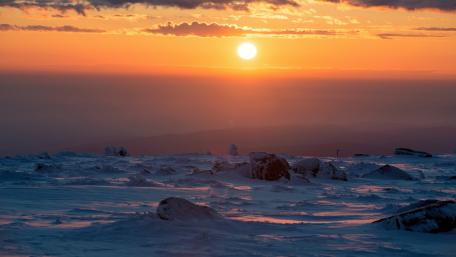 Majestic Sunset Over Snowy Landscape wallpaper