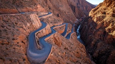 Winding Road Through Majestic Mountains wallpaper