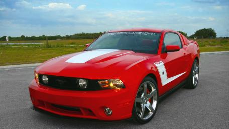 Sleek Red Muscle Car in Action wallpaper