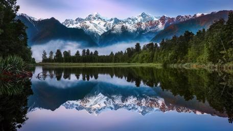 Majestic Mountains Reflecting on Tranquil Waters wallpaper