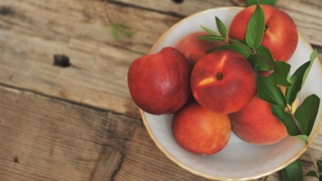 Vibrant Nectarines in a Rustic Bowl wallpaper