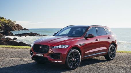 Sleek Red SUV by the Shoreline wallpaper