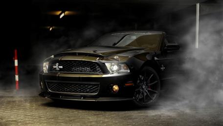 Sleek Black Sports Car in Mysterious Foggy Scene wallpaper