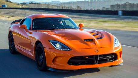 Sleek Orange Sports Car on the Move wallpaper