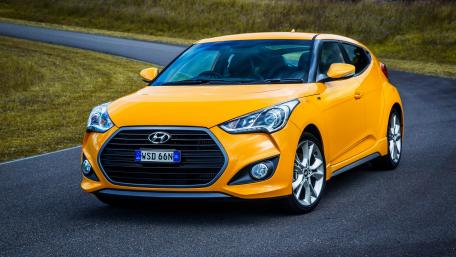 Vibrant Yellow Hyundai Coupe on a Scenic Road wallpaper