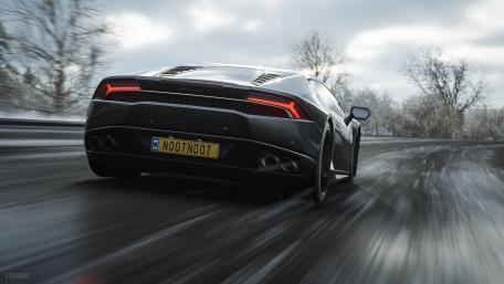 Sleek Black Sports Car on Icy Road wallpaper