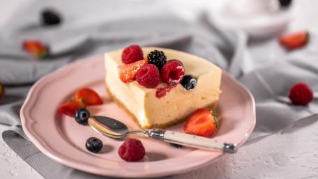Delicious Cheesecake with Fresh Berries on a Plate wallpaper