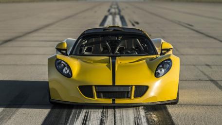 Sleek Yellow Supercar on the Runway wallpaper
