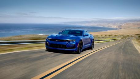 Sleek Blue Chevy Camaro on Coastal Roadway wallpaper
