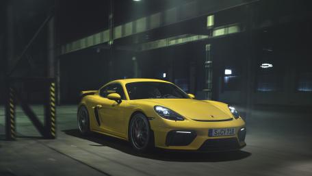 Striking Yellow Sports Car in an Industrial Setting wallpaper
