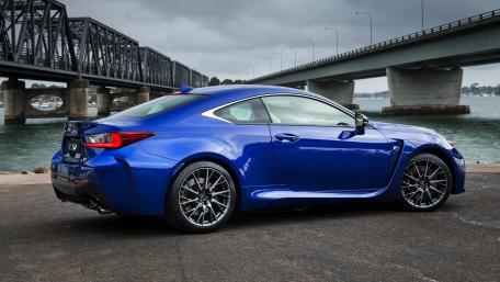 Sleek Blue Sports Car by the Bridge wallpaper