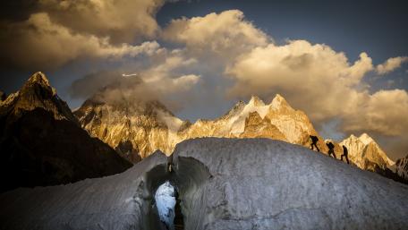 Majestic Mountain Peaks Amidst Glowing Clouds wallpaper