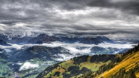 Majestic Mountains Under Dramatic Clouds wallpaper